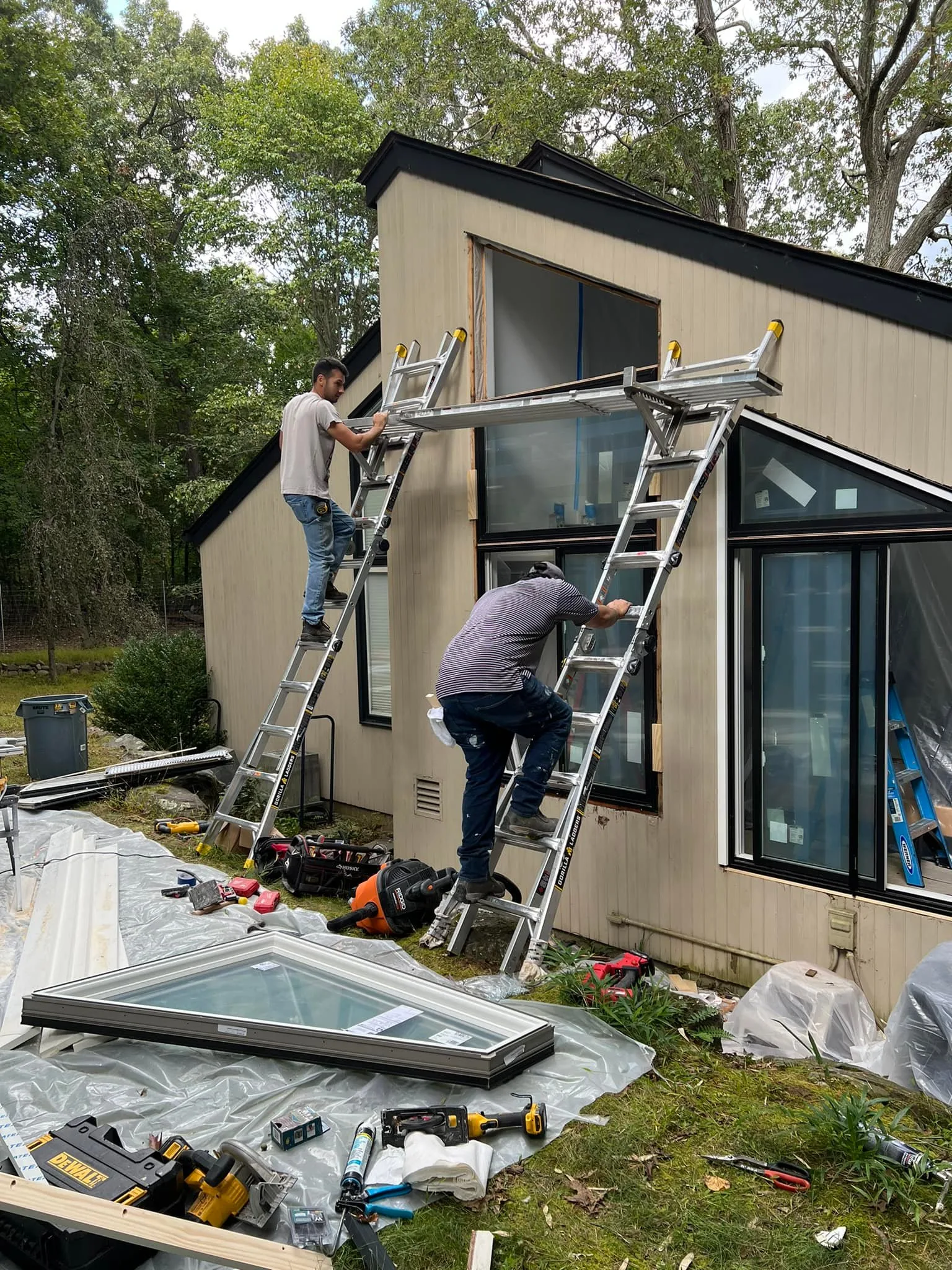 Installation team preparing opening for new Andersen windonws.