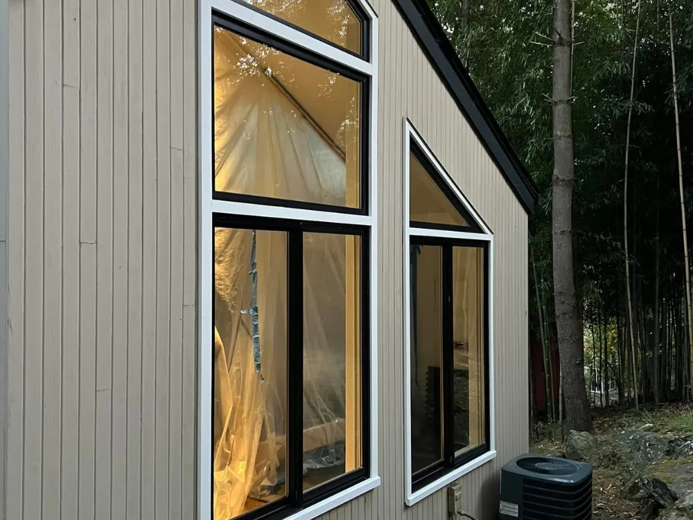 Final result of installed Andersen windonws with black and white trim.