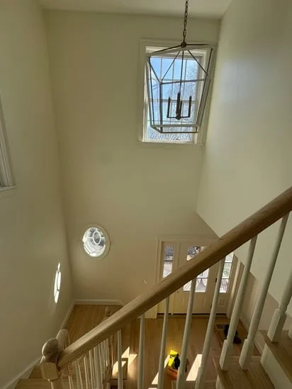 bright and renovated staircase with hardwood flooring