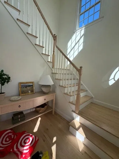 restored staircase with refinished handrail and floors